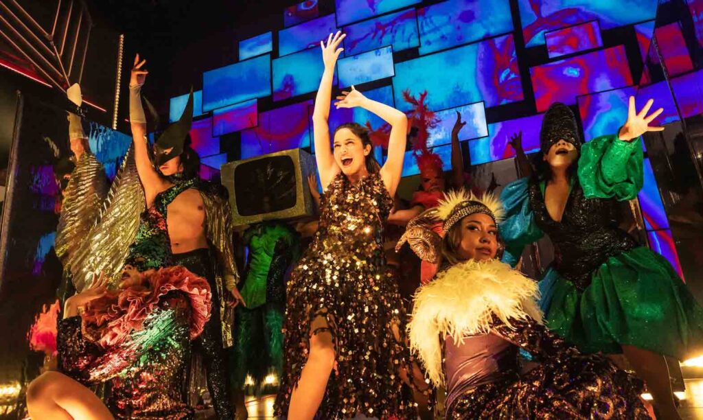 Arielle Jacobs (center) in Broadway disco pop musical “Here Lies Love.” BILLY BUSTAMANTE, MATTHEW MURPHY, EVAN ZIMMERMAN