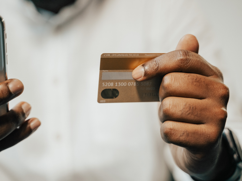 A man holding a credit card
