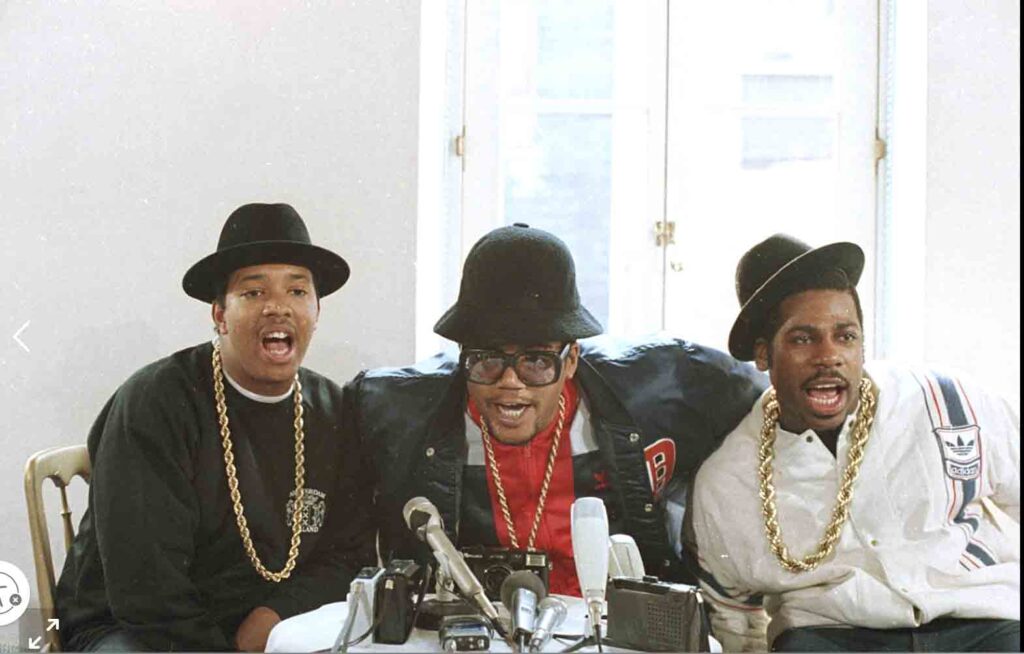 Rap group RUN D.M.C., in London for two concerts, talk during a news conference. The group, left to right, is Joseph Simmons, Darryl McDaniels, and Jason Mizell. AP PHOTO