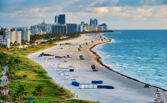 Photo of beach in Miami with several buildings in the background.