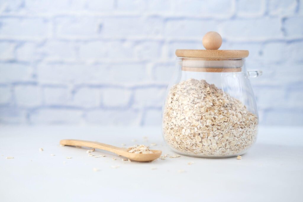 Oats in glass jar with wooden spoon