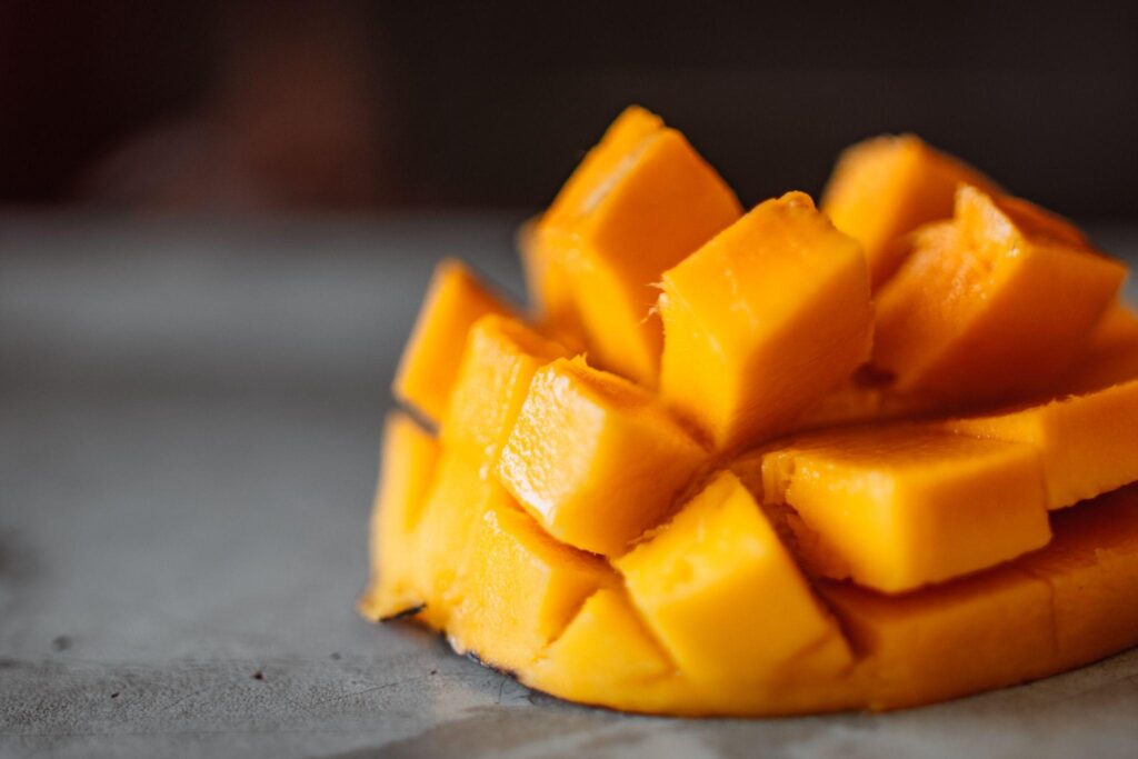 Closeup photo of sliced mango on stone surface