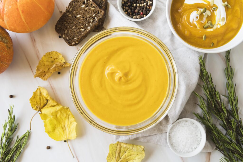 Fresh pumpkin puree in glass bowl with other ingredients