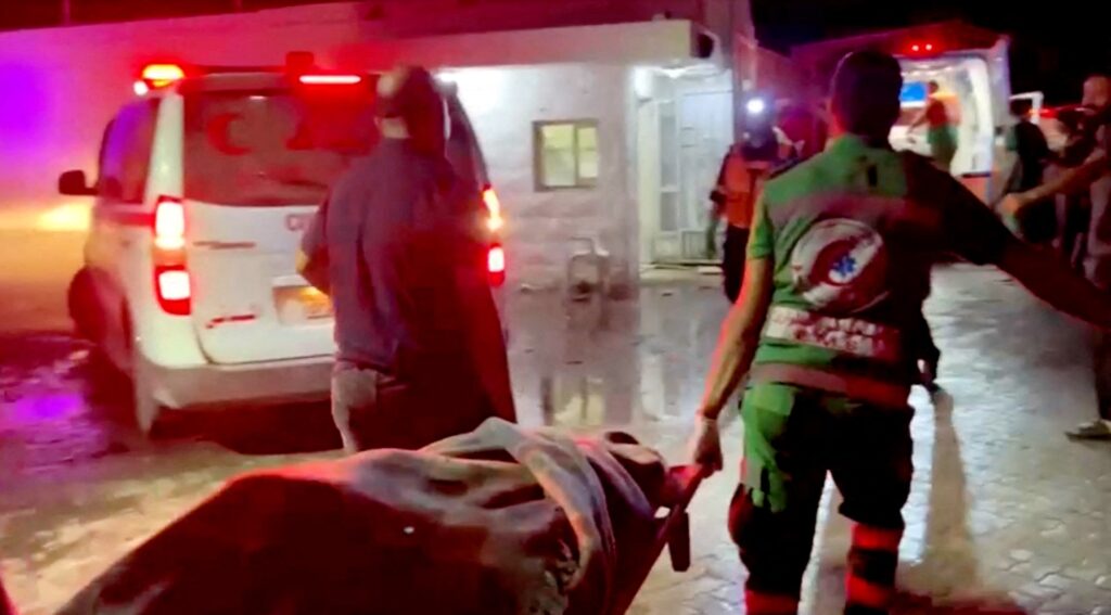 Rescue personnel work at scene at the Gaza hospital, At Al-Ahli Hospital, after hundreds of Palestinians were killed in the blast that Israeli and Palestinian officials blamed on each other in this screen grab obtained from video on Oct. 17, 2023 | Screencap from Reuters TV