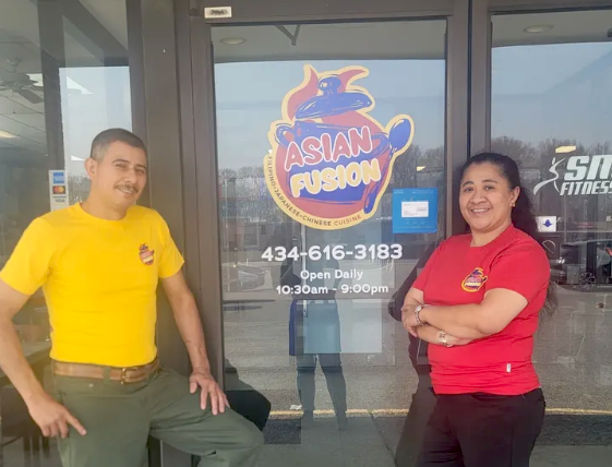 The Asian Fusion owners happily welcoming customers into their restaurant