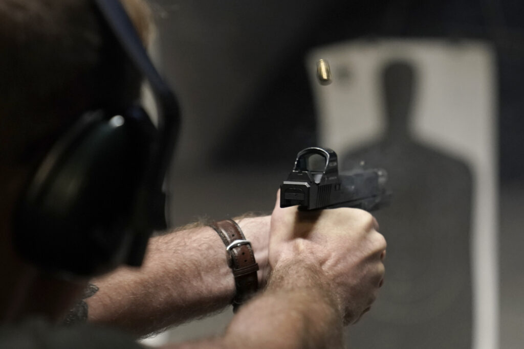 Man holding gun aiming at practice target