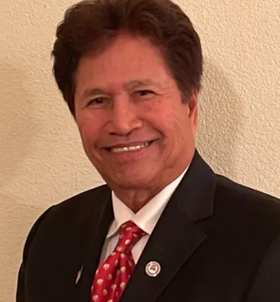 Ely De La Cruz Ayao in a suit with a red tie