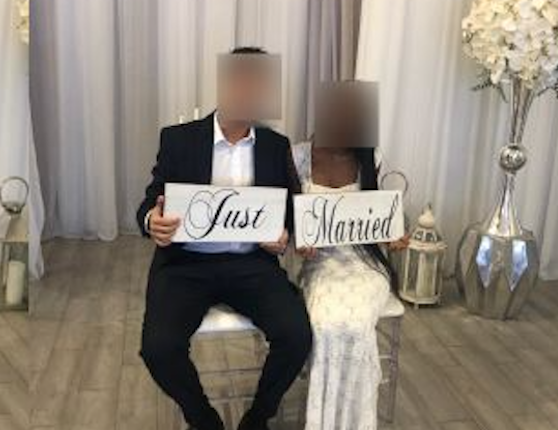 Newly married couple with sign, "Just Married"