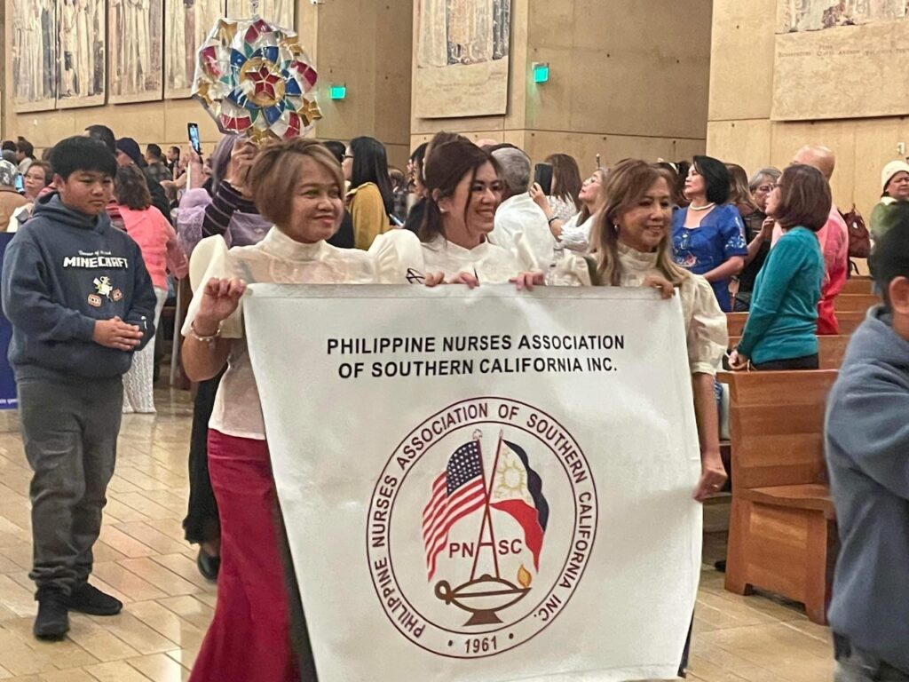 Nurses holding banner during parol procession