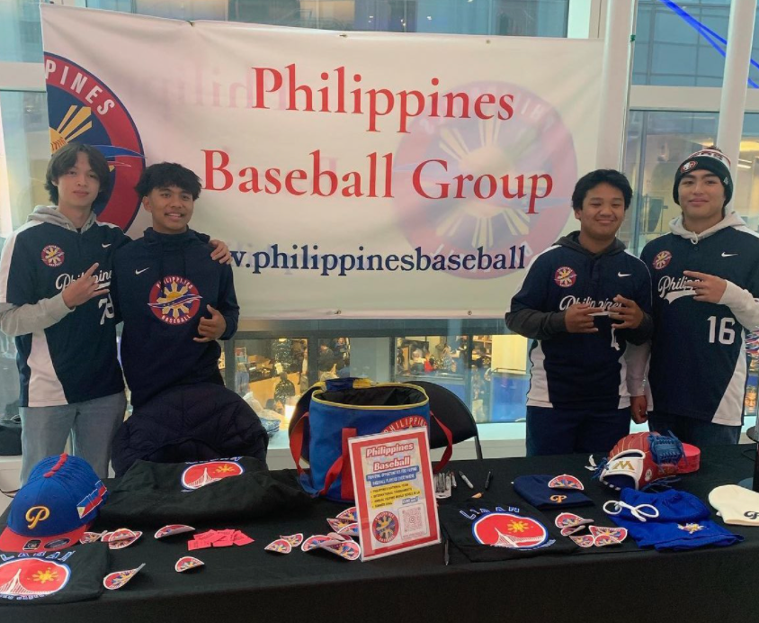 PBG players pose behind table with merchandise display