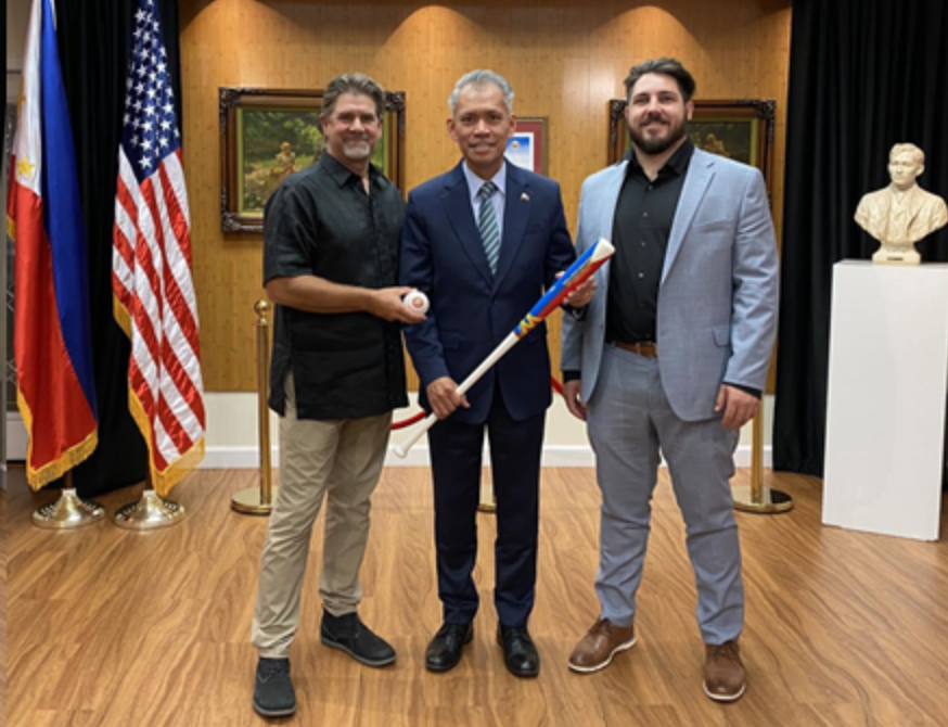 PCG Ferrer holding baseball bat posing for photo with PBG leaders