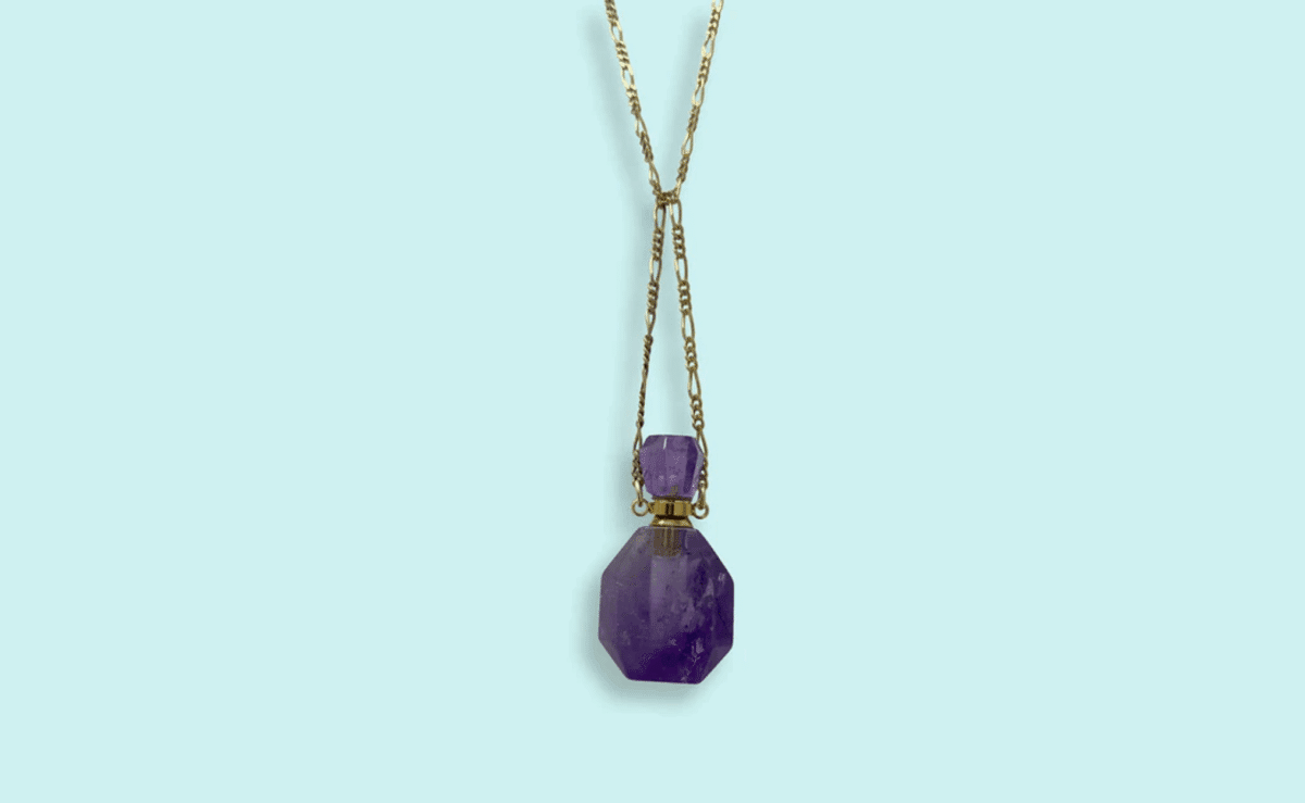 Amethyst pendant necklace with a small perfume bottle embedded inside.