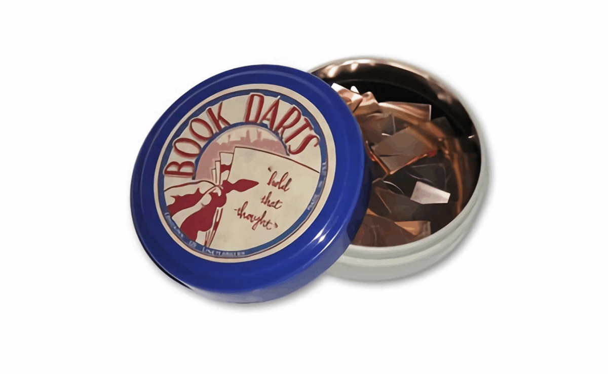 Metal Book Darts bookmarks clipped onto pages for precise line marking.