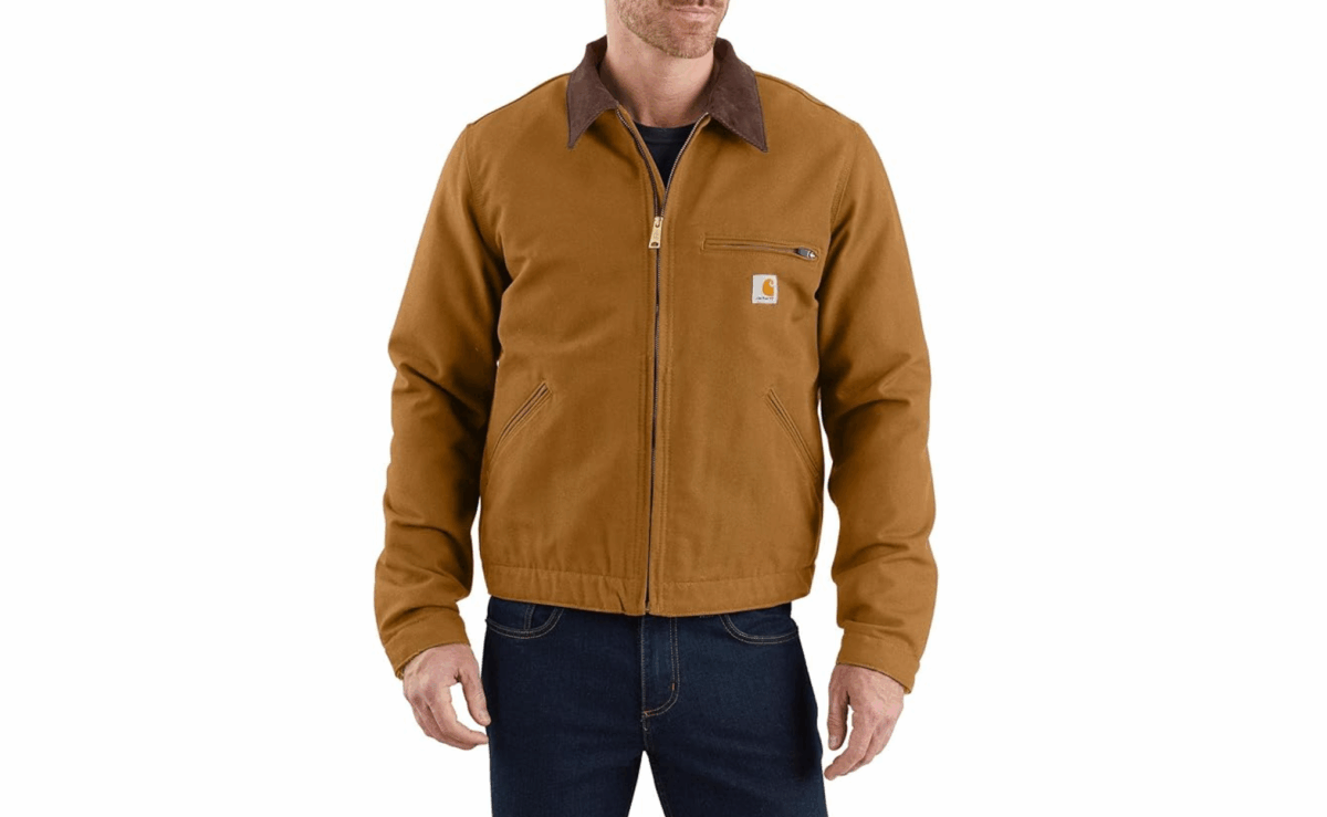 Carhartt brown duck Detroit jacket with corduroy collar and zip front worn by a man.