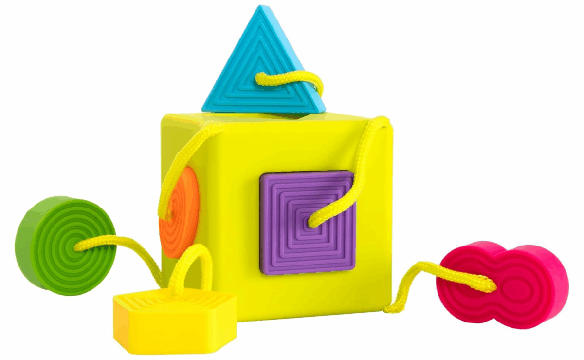 Colorful Fat Brain Toys Oombee Cube with soft tethered shapes for sorting and sensory play.