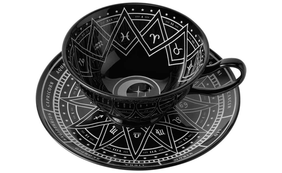 Glossy black Killstar cup and saucer set featuring celestial zodiac artwork.
