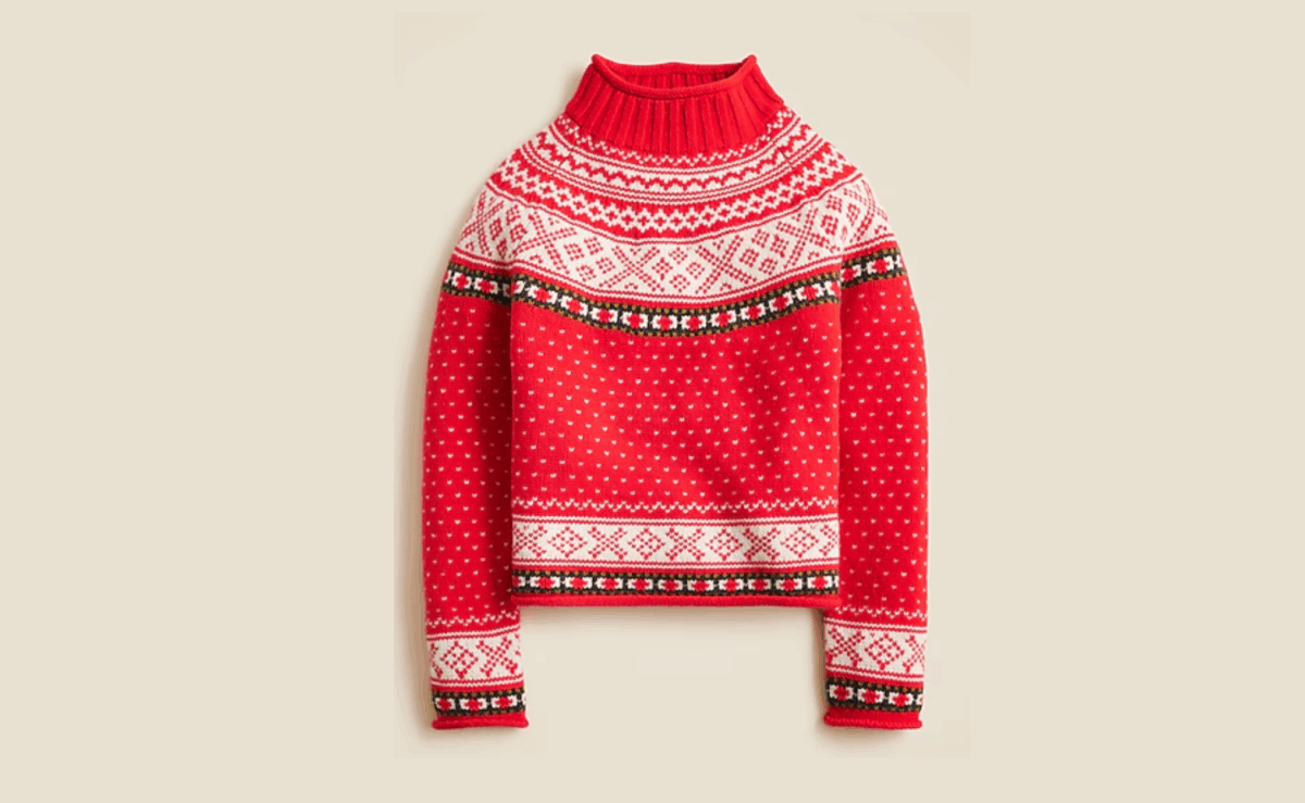 Cozy lambswool rollneck sweater in a relaxed fit, shown folded with ribbed collar and cuffs.