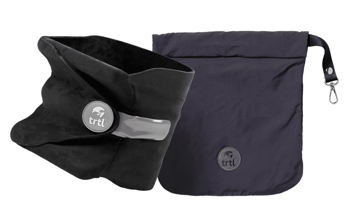 Trtl travel neck pillow wrapped around a traveler’s neck for support.