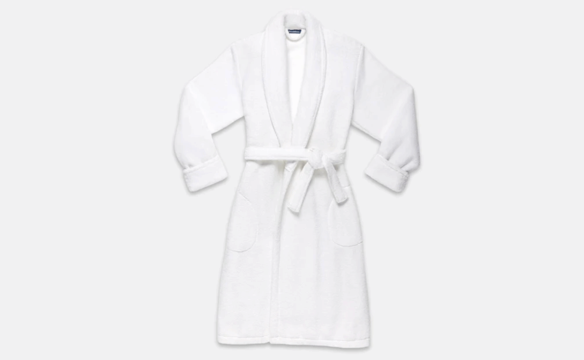 Luxuriously soft white plush robe with shawl collar and belt tie.