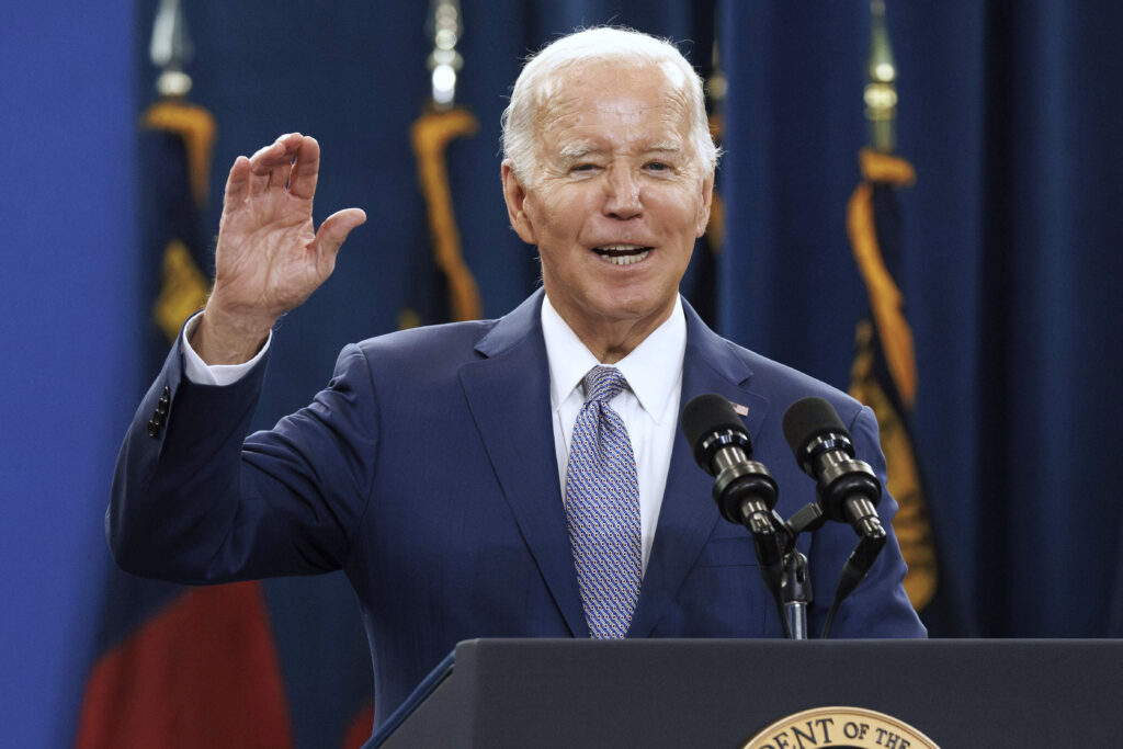 Biden with one hand raised