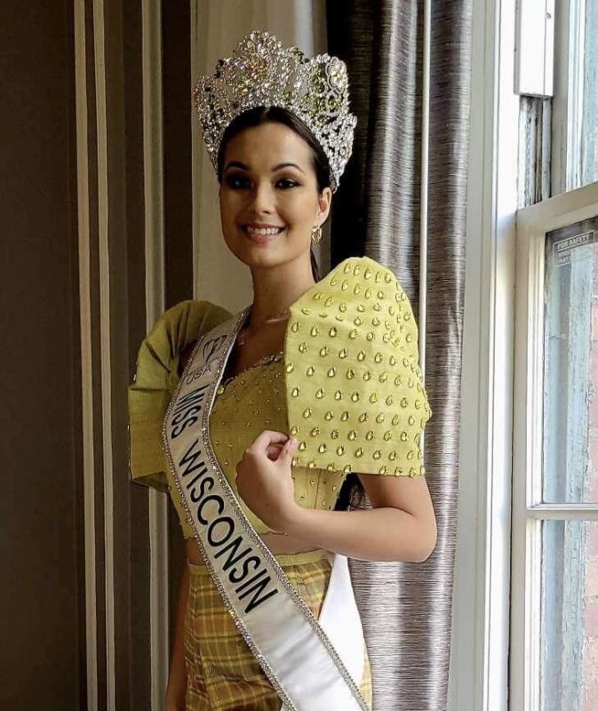 Miss Earth USA wears a crown and a light green Filipiniana gown