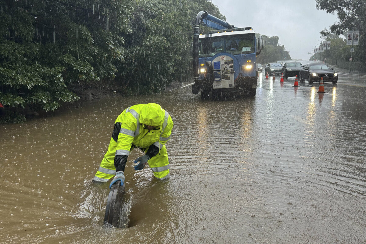 Government workers on flooded road