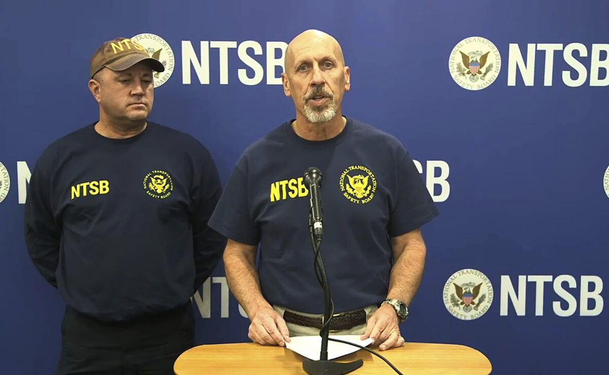 Officials in uniform speaking at press conference