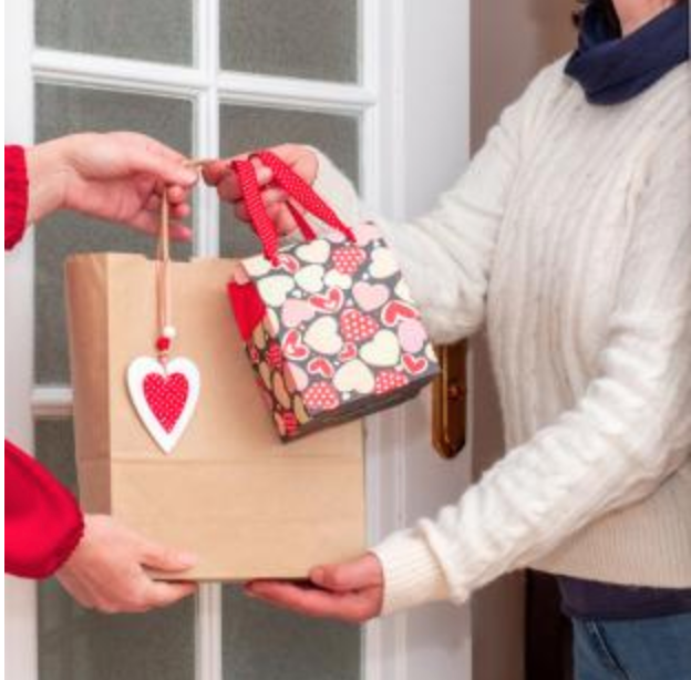 Lady receiving a Valentine's gift bag