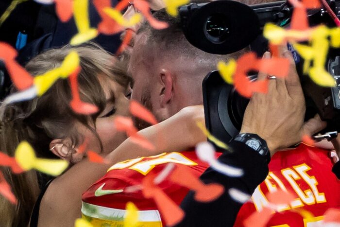 Kansas City Chiefs' Travis Kelce kisses Taylor Swift as they celebrate. 