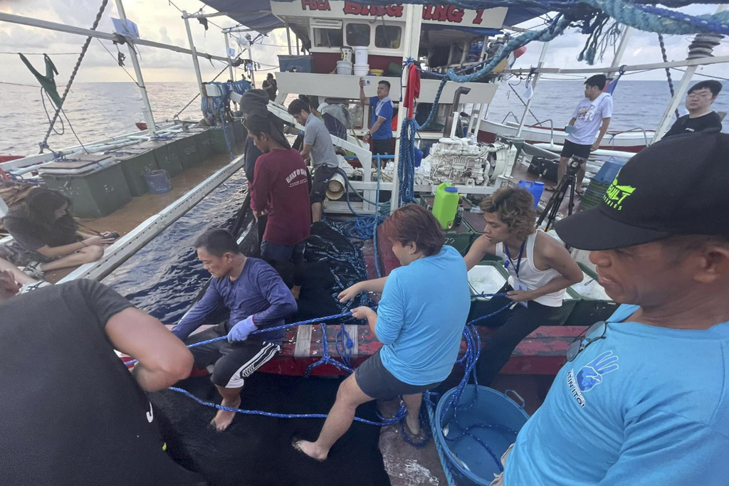 Filipino activists decide not to sail closer to disputed shoal