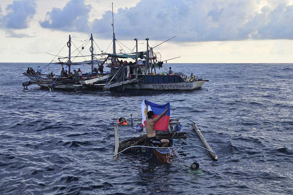 Filipino activists decide not to sail closer to disputed shoal