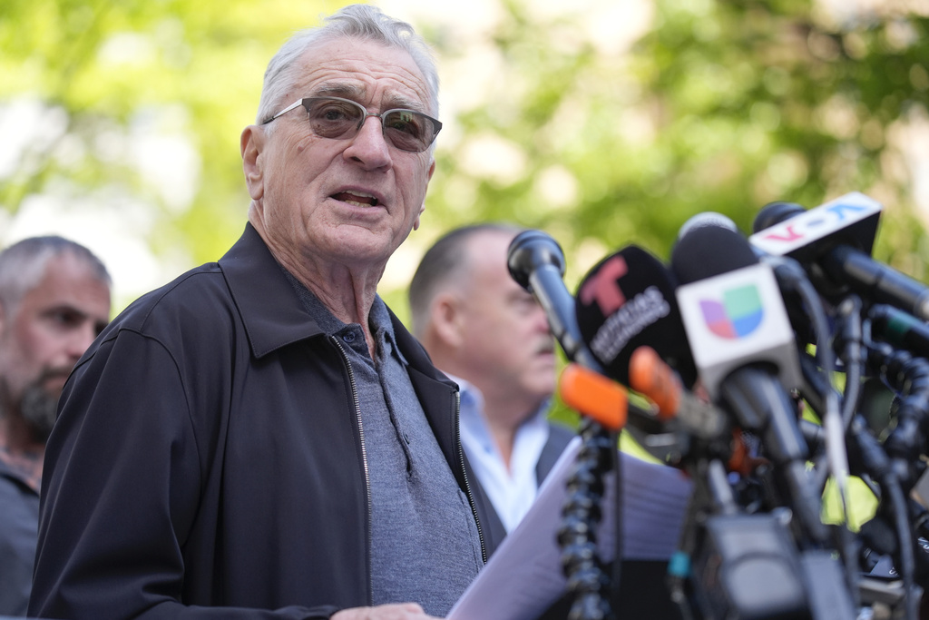 Robert De Niro, center, argues with a Donald Trump supporter after speaking to reporters in support of President Joe Biden across the street from Trump's criminal trial in New York, Tuesday, May 28, 2024. (AP Photo/Seth Wenig)