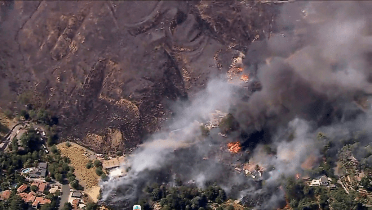 Fast-moving Southern California wildfire torches hillside homes