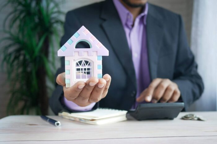 A man holding a house