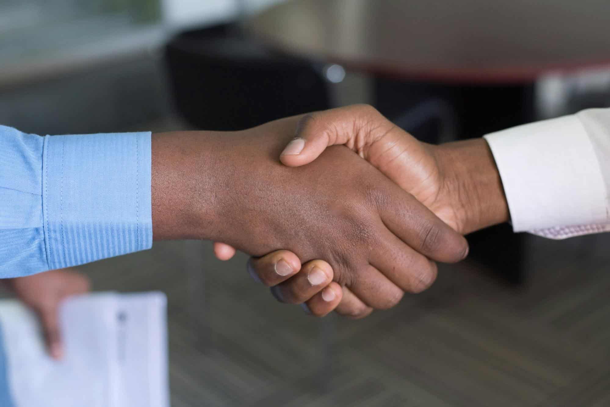 Close-up of a handshake symbolizing USABrightLine’s personalized document preparation services, accuracy, and customer satisfaction.