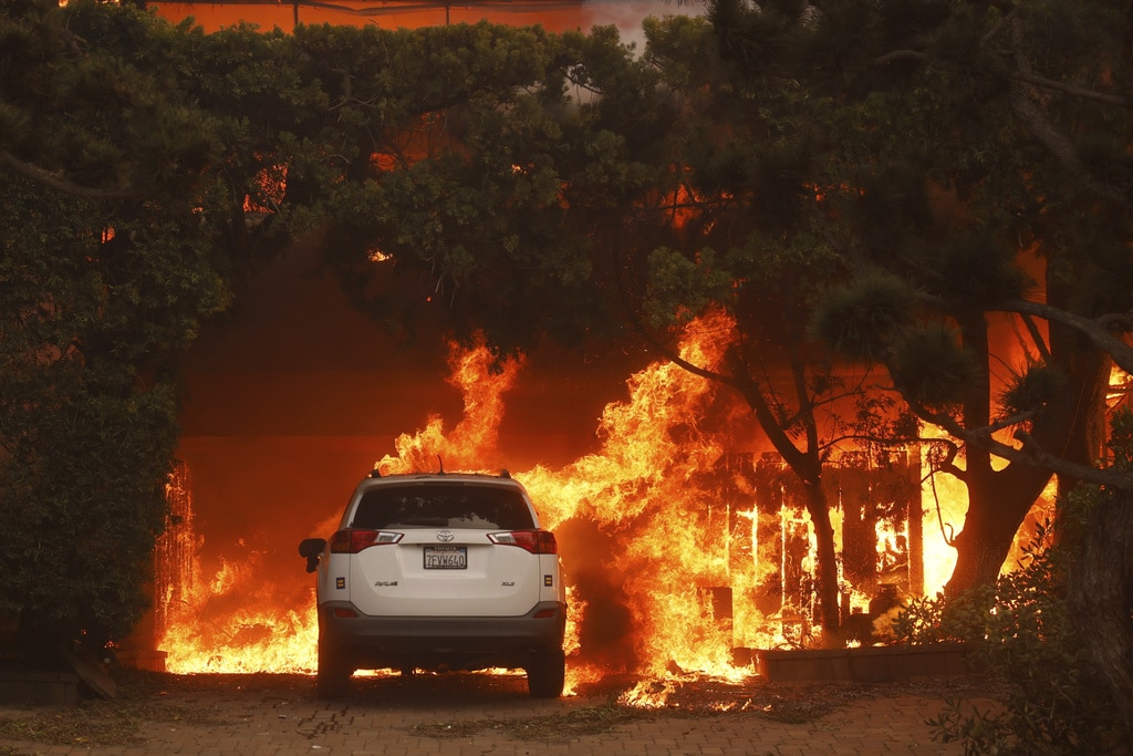 Wildfires burn out of control across LA and kill 5 as thousands flee homes