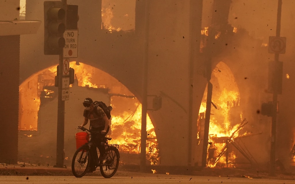 Wildfires burn out of control across LA and kill 5 as thousands flee homes