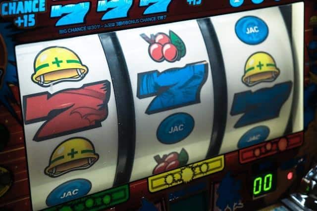 A close-up of a slot machine displaying a winning combination with symbols such as cherries, helmets, and sevens.