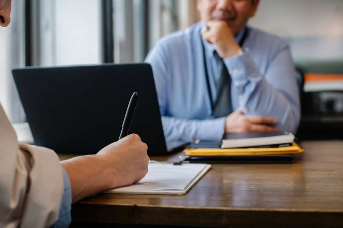 Two individuals in a loan consultation discussing the benefits and drawbacks of choosing Republic Finance for personal lending options