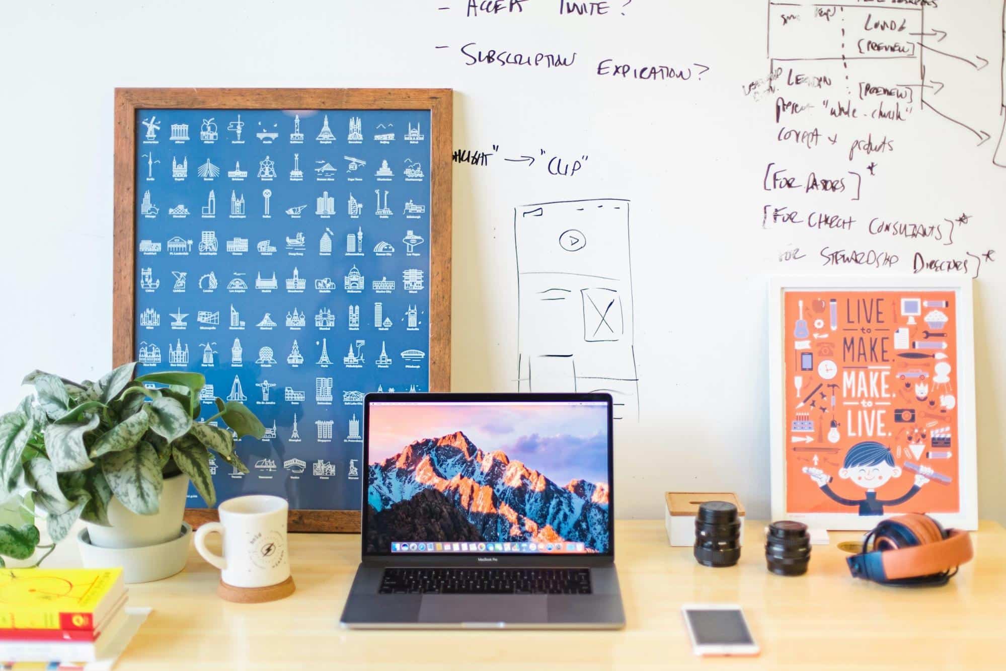 Laptop on a desk with a smartphone and workspace items, representing Fig Loans' online lending and mobile accessibility.