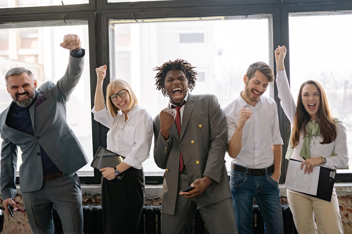 Group of happy professionals celebrating a successful debt relief outcome, representing TurboDebt client success stories.