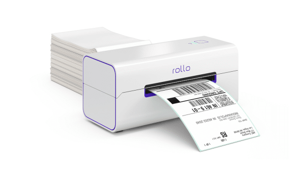 Rollo X1040 wireless thermal printer printing a shipping label, with stacked labels in the background.