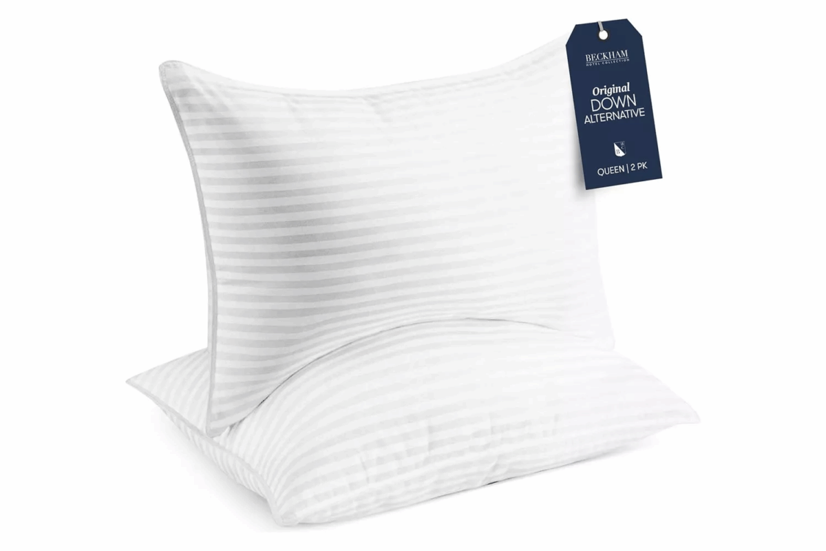 Two white Beckham Hotel Collection queen pillows with striped design and down-alternative fill.