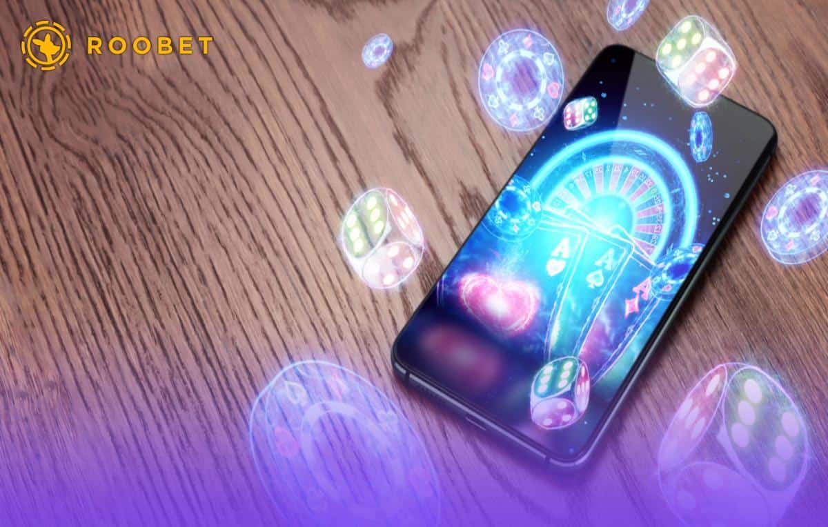 Interfaccia del casino mobile Roobet su smartphone, che mostra giochi slot e live casino in primo piano