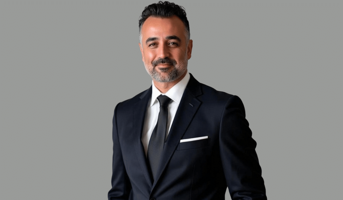 Professional portrait of Matt Kazemi, a mortgage executive, wearing a dark suit and tie against a neutral gray background.